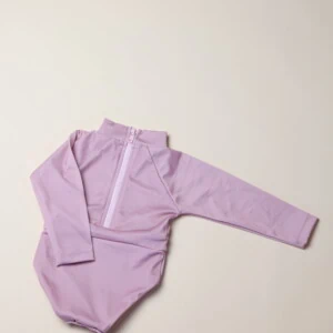 A child's June Long Sleeve One-Piece bodysuit in lilac on a white surface.