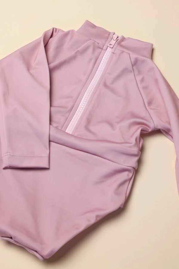 A June Long Sleeve One-Piece with a zipper on it.