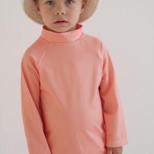 A young boy in a Sorbet Summer - Nella Rash Shirt and shorts.