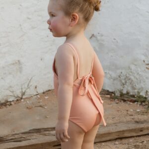 A little girl wearing a Sorbet Summer - Mara one-piece swimsuit.