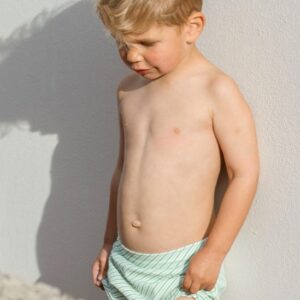 A young boy wearing a Retro Wave By Ina - Lumi Short Swim Nappy.
