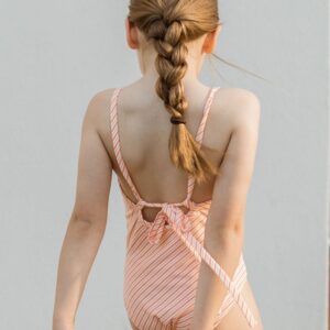 A little girl wearing the Retro Wave By Ina - Mara One-Piece swimsuit.