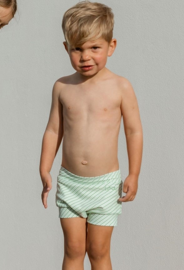 A boy and a girl standing next to each other wearing the Retro Wave By Ina - Lumi Short Swim Nappy.
