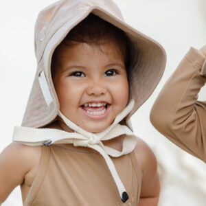 A baby wearing a WS - Golden Meadows Collection - Golden Sun Bucket Hat.